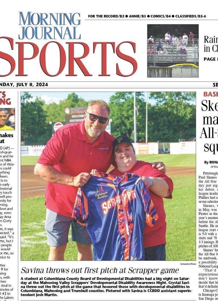 the front page of a newspaper with a picture of two people holding a scrappers jersey.