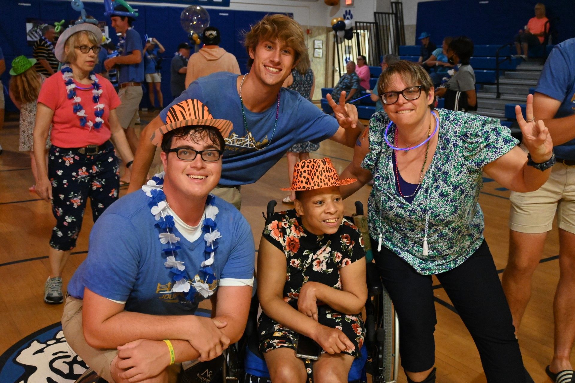 a group of people are posing for a picture in a gym .