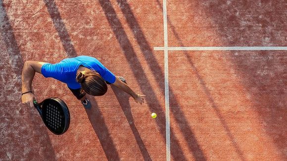 An aerial view of a person playing tennis on a court