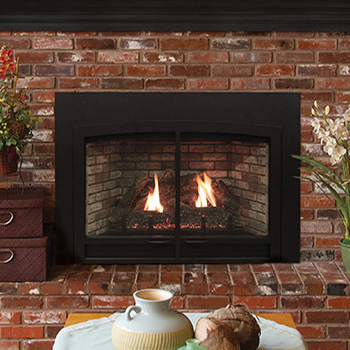 Gas fireplace with flames burning, set into a brick wall.