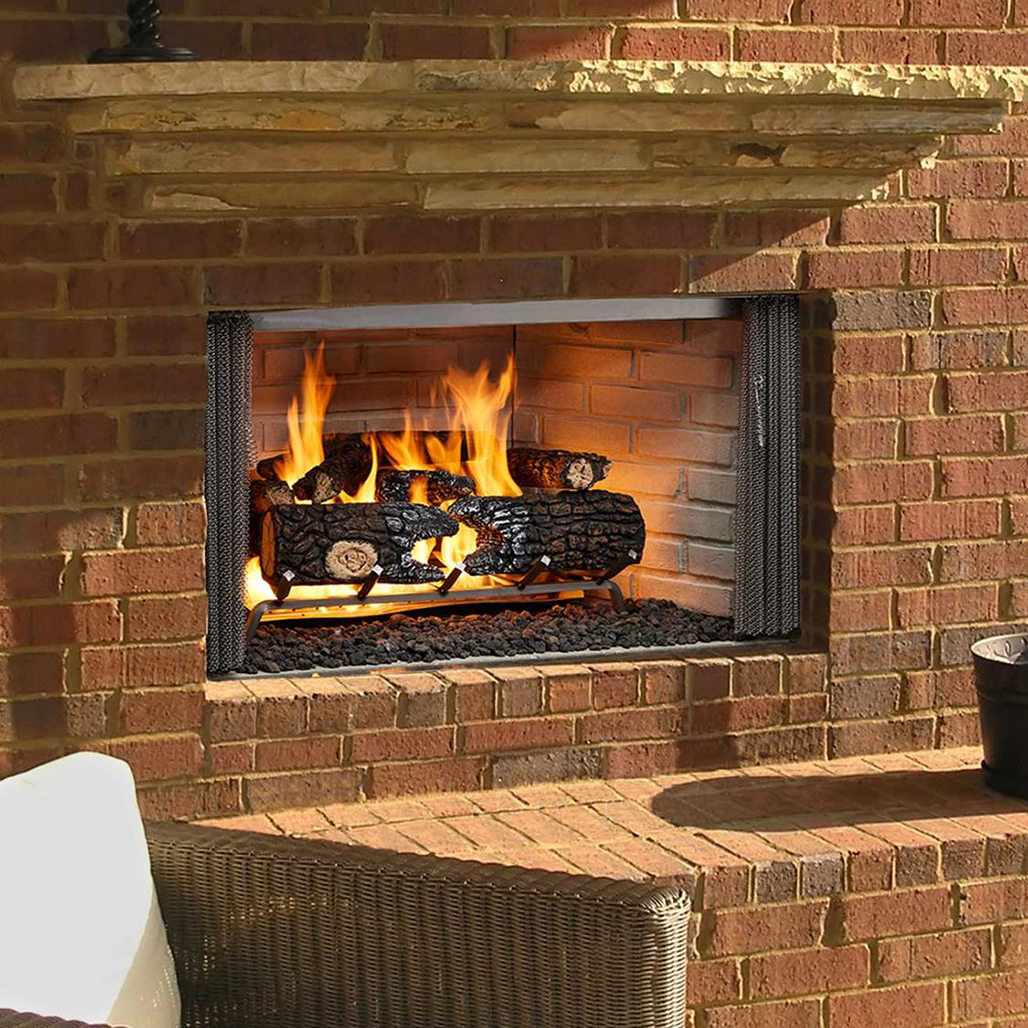Outdoor brick fireplace with burning logs.