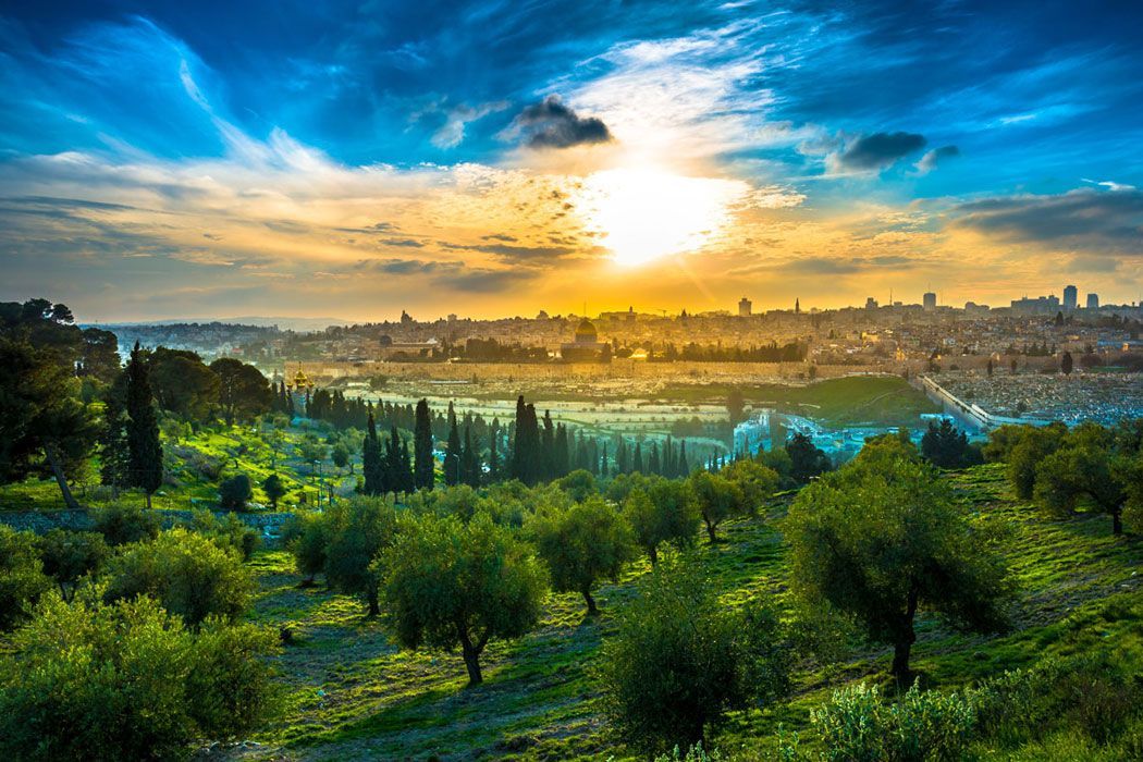 the sun is setting over the city of jerusalem