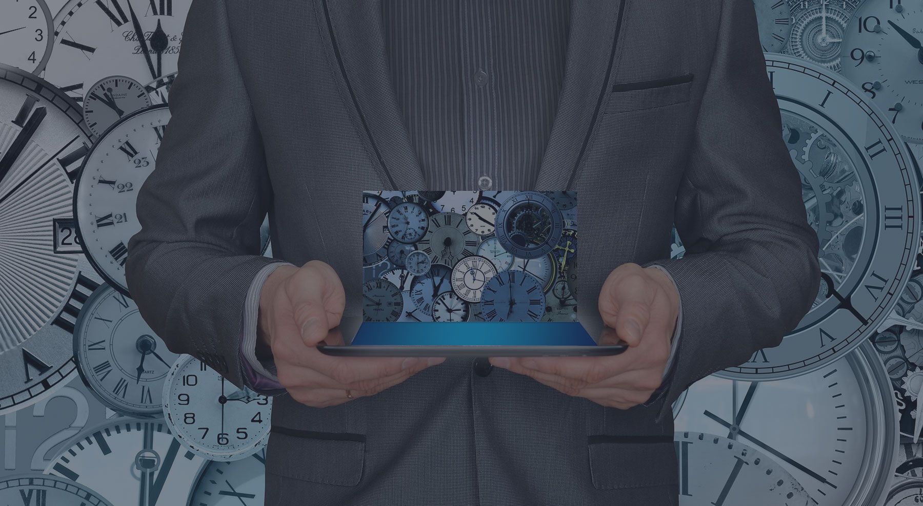 a man in a suit is holding a iPad with a picture of clocks on it.