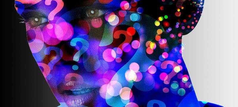 a woman 's face is surrounded by colorful question marks .
