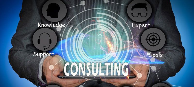 a person holding a tablet with the word consulting on it