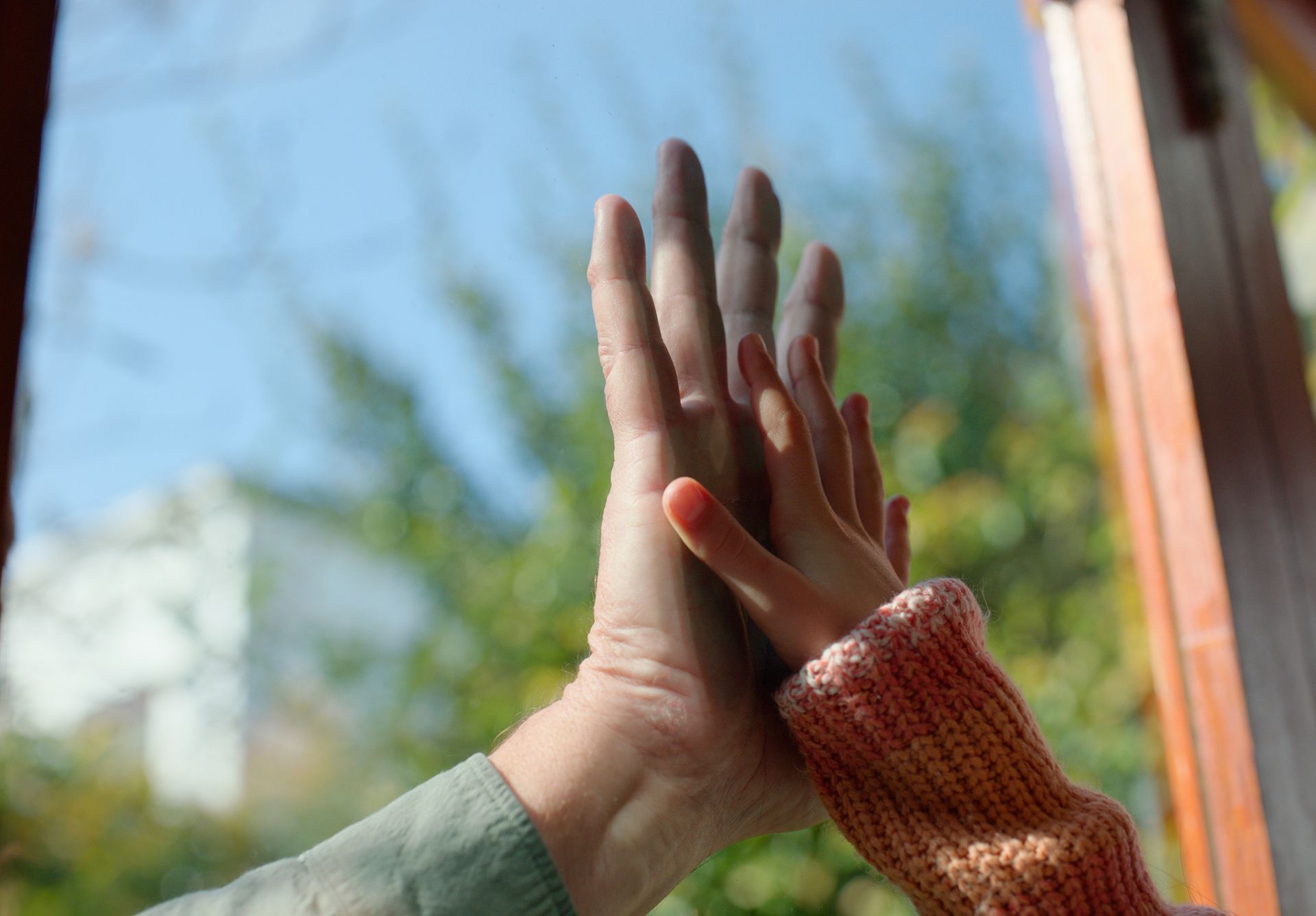 A woman and a child are giving each other a high five.