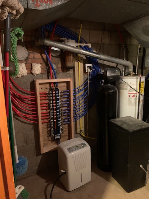 A room with a water heater and a dehumidifier