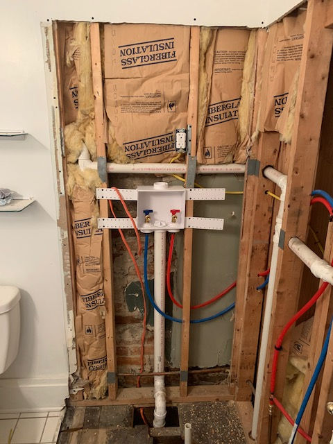 A bathroom with a box that says insulation on it