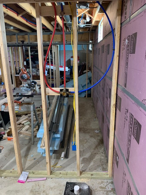 A man is taking a picture of himself in a room under construction.