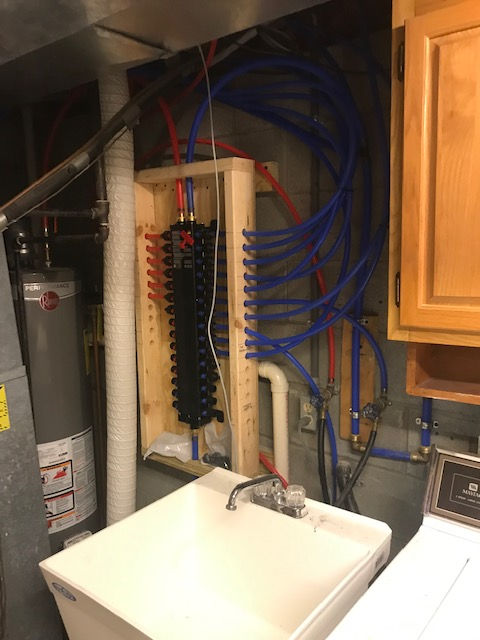 A laundry room with a sink and a washer and dryer.