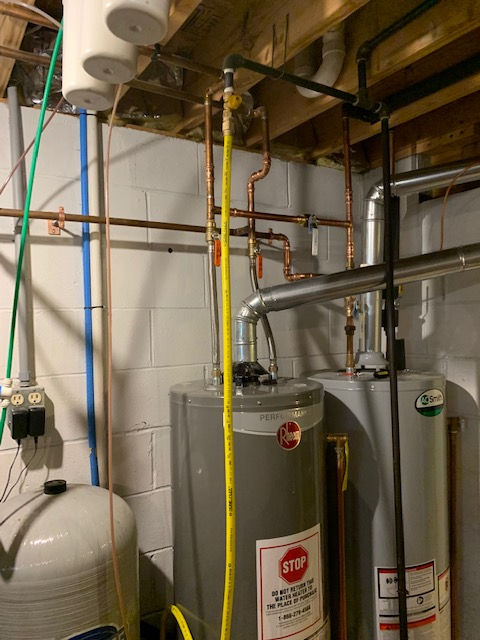 A water heater with a stop sign on it