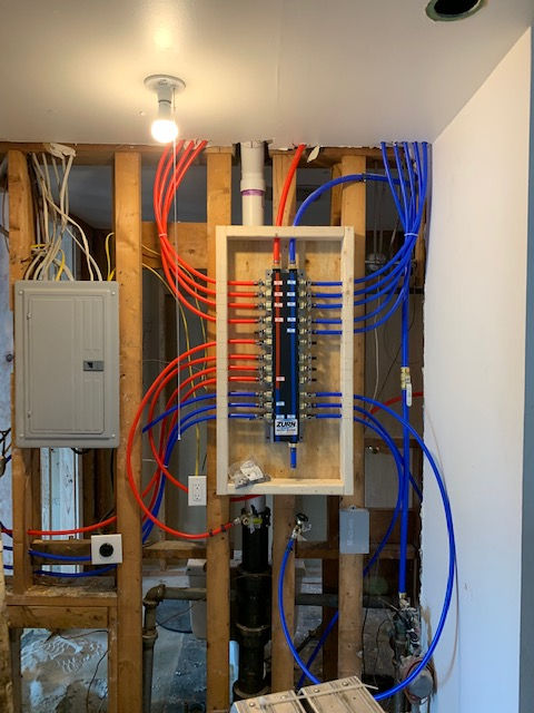 A bunch of wires are connected to a box on a wall