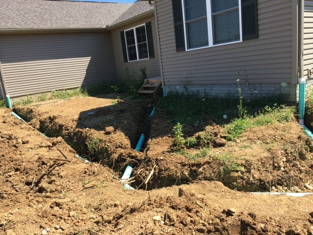 A house with a lot of dirt in front of it