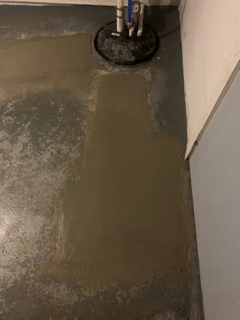 A close up of a concrete floor in a basement.