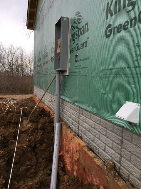 A brick wall with a green tarp on it