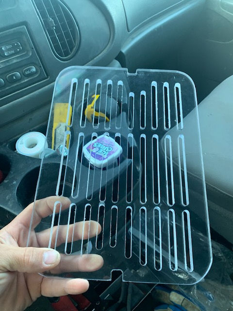 A person is holding a clear plastic tray in their hand