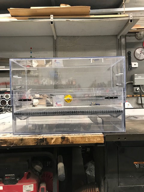 A clear plastic container is sitting on top of a wooden table.