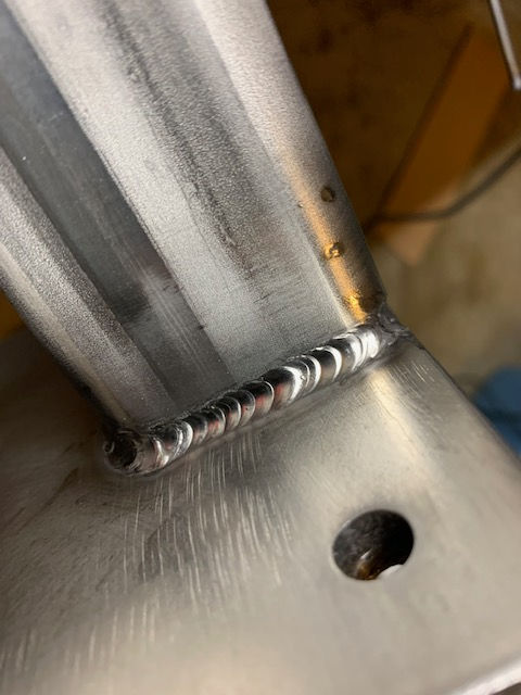 A close up of a metal pipe with a hole in the middle.