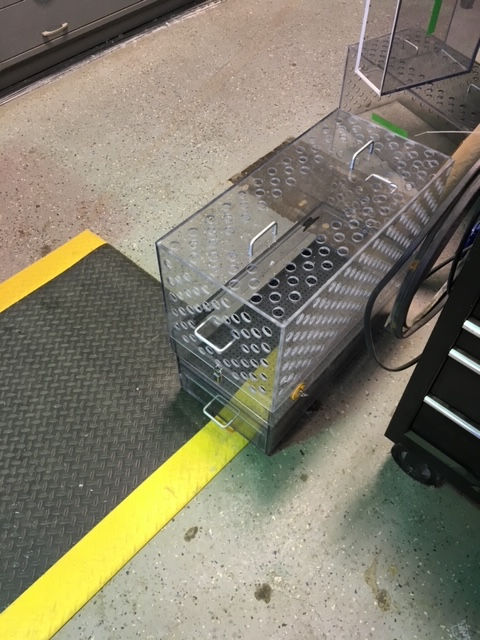 A clear box with a yellow stripe on the floor