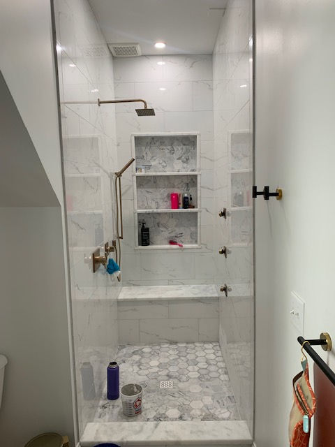 A bathroom with a walk in shower and a bathtub.