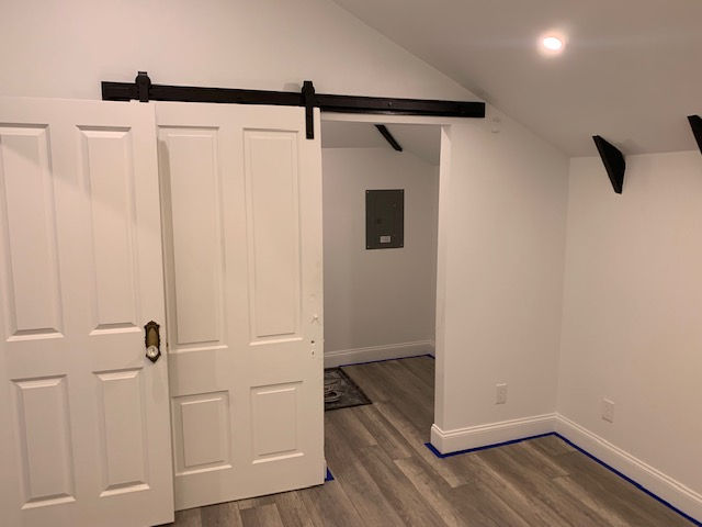 A room with white walls and a sliding barn door.