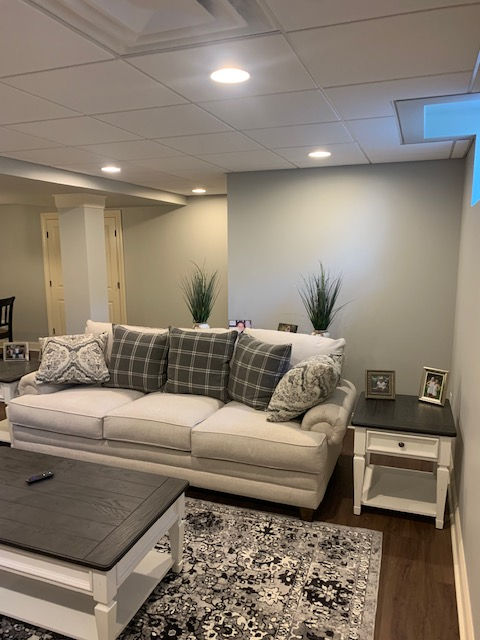 A living room with a couch , coffee table , and rug.
