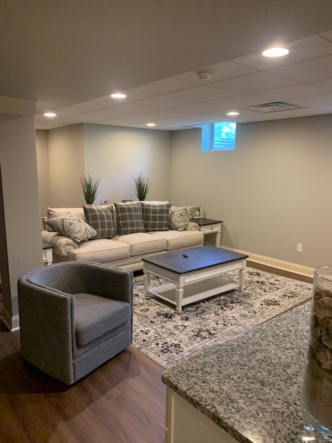 A living room with a couch , chair and coffee table