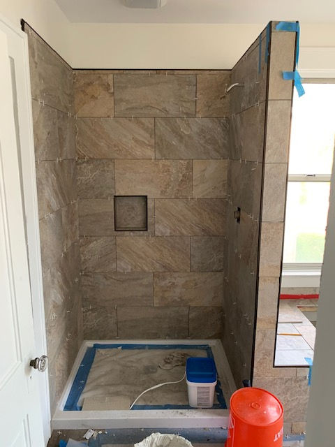A shower stall is being built in a bathroom