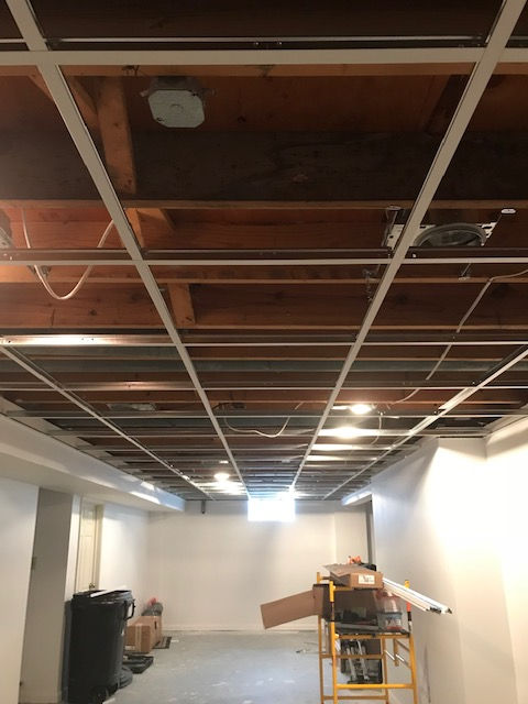 A basement with a ceiling that is being remodeled.