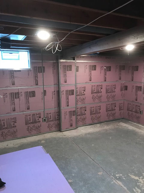 A room with a lot of boxes on the wall and a purple mat on the floor.