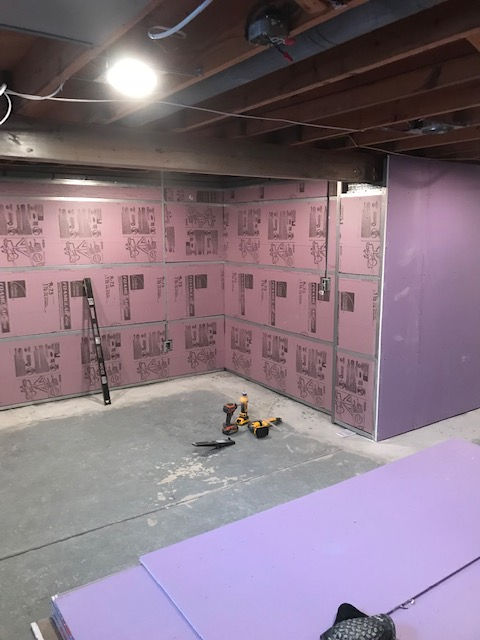 A room with purple walls and a ladder on the floor.