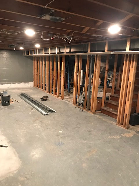 A basement under construction with wooden beams and stairs