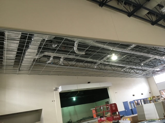 A large room with a ceiling that is being remodeled.