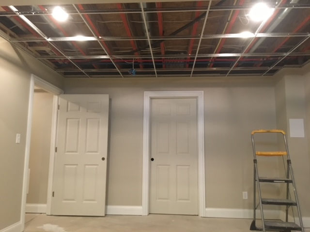 An empty room with a ladder in the corner