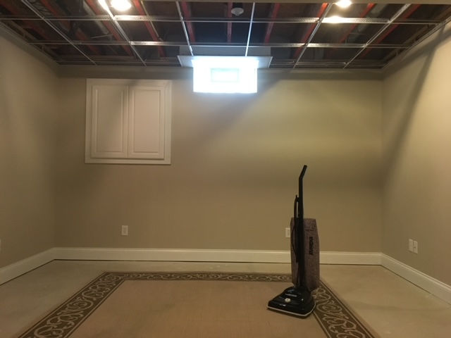 An empty room with a vacuum cleaner on the floor