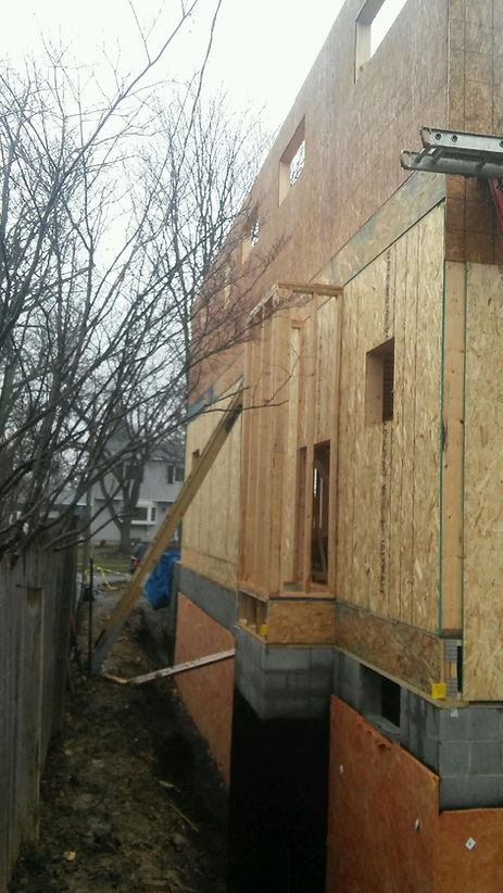 A house is being built in the backyard of a house.