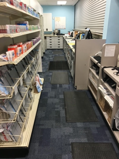 The inside of a pharmacy with shelves filled with various items