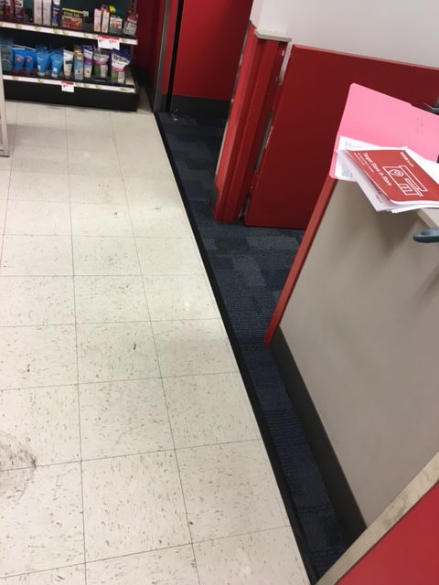 A counter in a store with a sign on it that says ' checkout '
