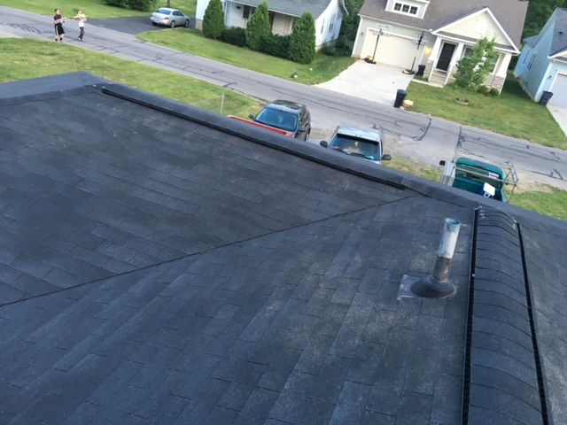 An aerial view of a roof with cars parked on it