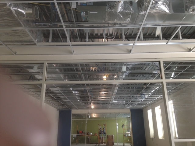 A room with a ceiling that is being built in a building.
