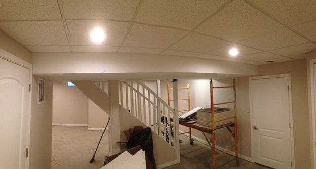 A basement with stairs and a scaffolding in it