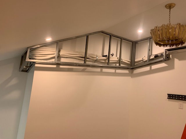 There is a chandelier hanging from the ceiling in the room.