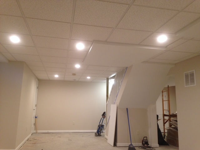 A basement with a staircase and a broom in it