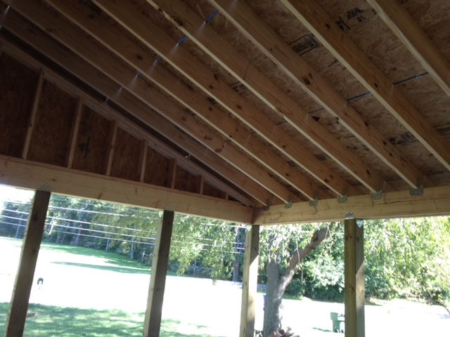 A wooden structure with a tree in the background