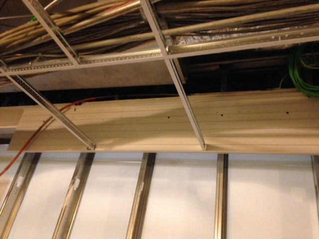 A ceiling with a bunch of wires hanging from it