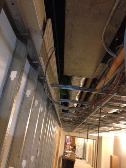 A hallway with a lot of wires hanging from the ceiling