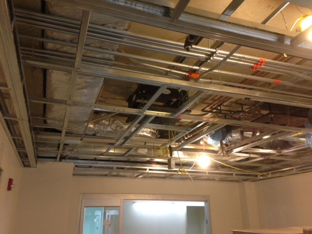 A ceiling with a lot of wires hanging from it