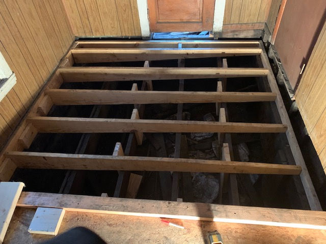 A wooden floor is being built in a room