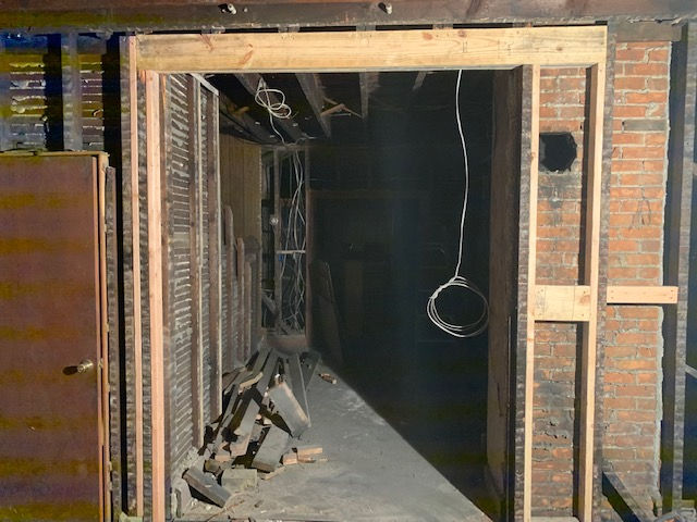 A brick wall with a wooden frame around it