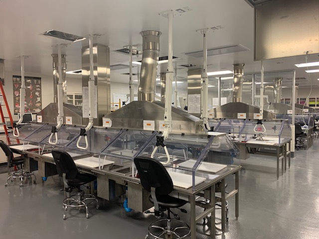 A large room with a lot of tables and chairs in it